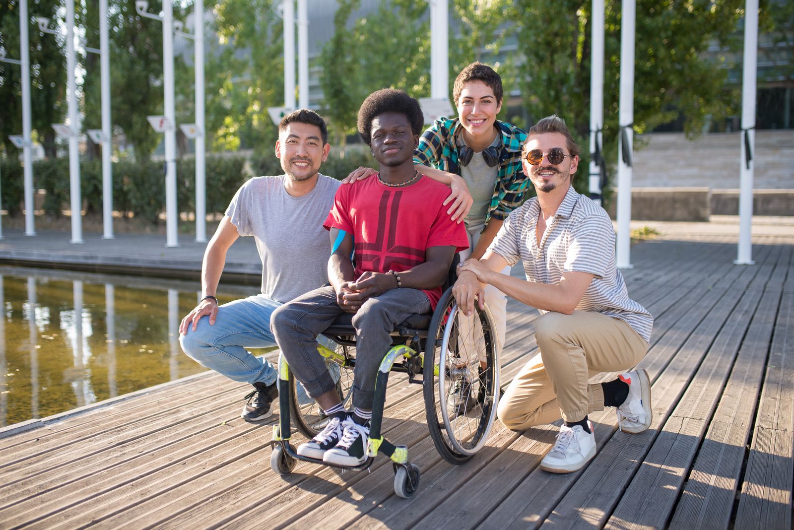 A diverse group of adults, including a wheelchair user, enjoying a community park together